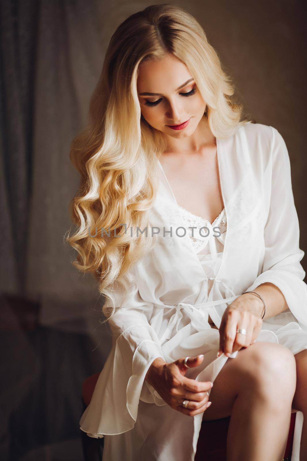 Beautiful blondie bride in bedroom, dreaming with closed eyes. by StudioLucky