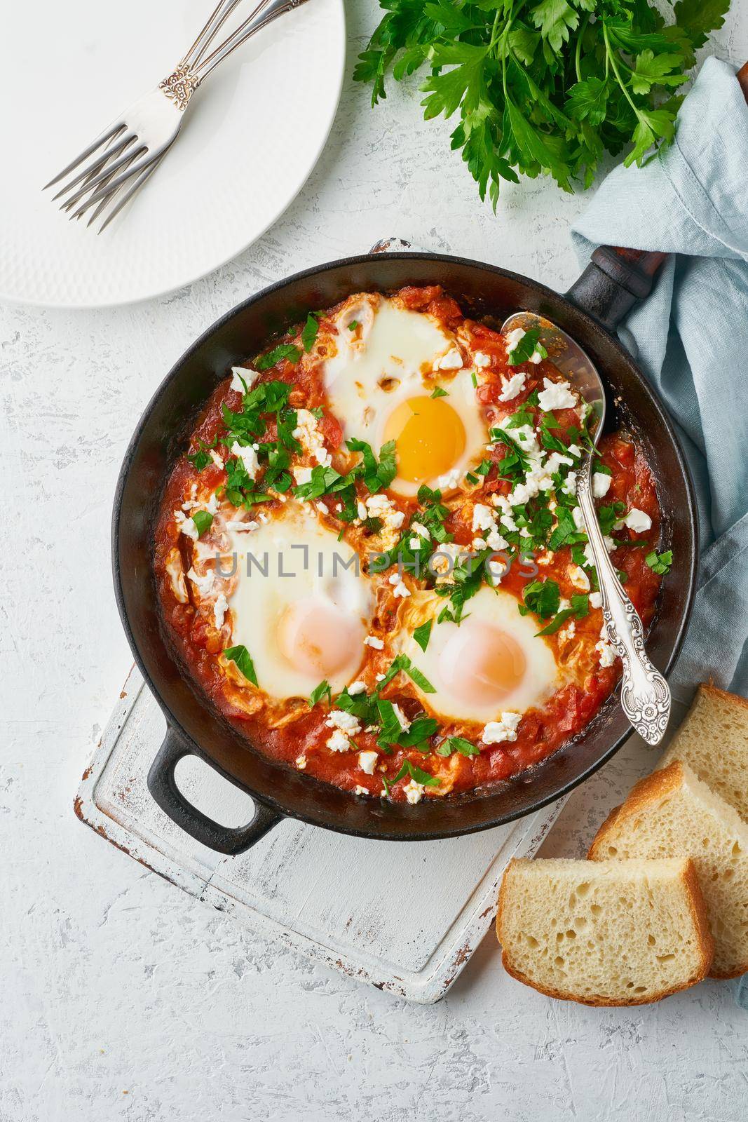 Shakshouka, eggs poached in sauce of tomatoes, olive oil. Mediterranean cuisine. by NataBene