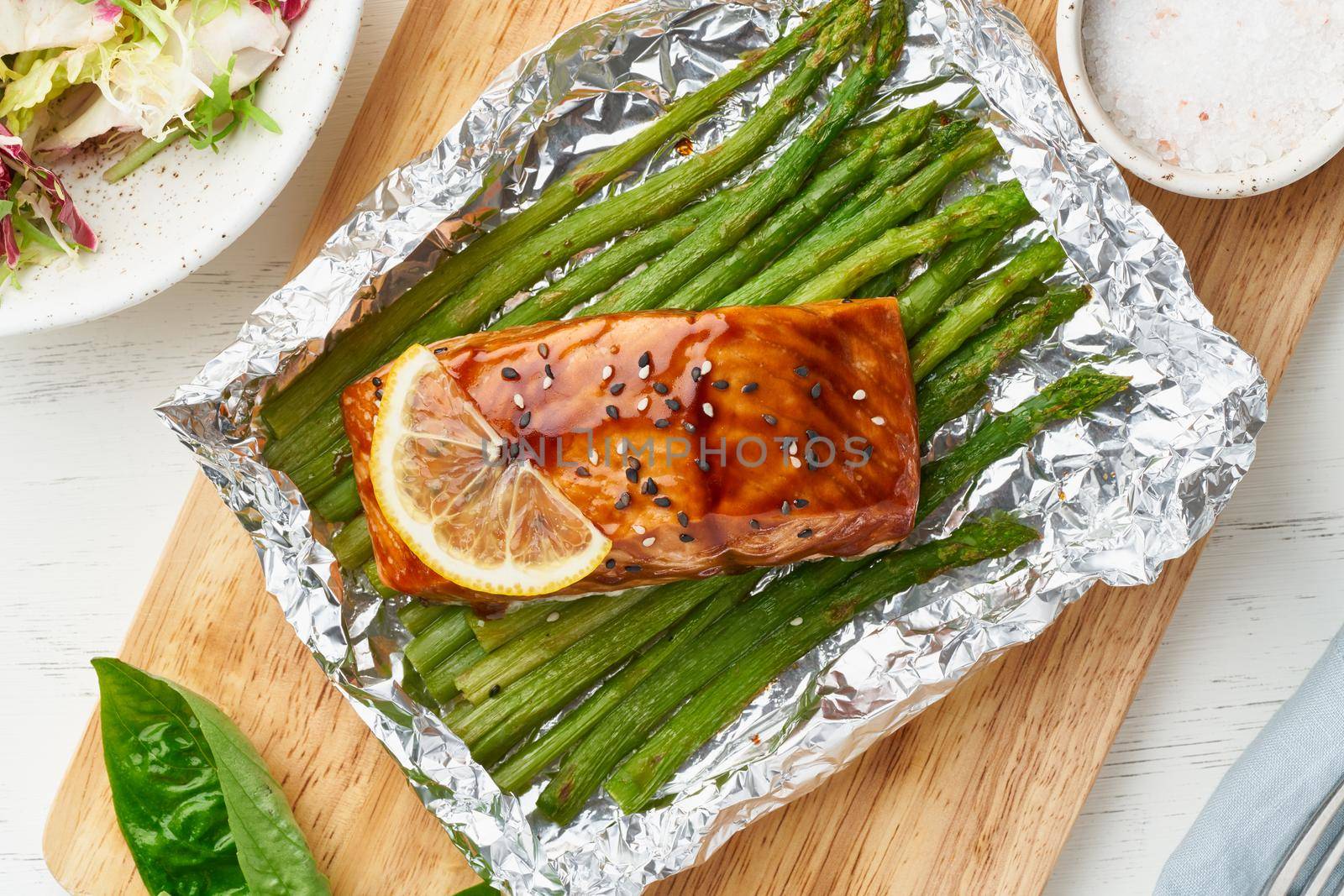 Foil pack dinner with fish. Fillet of salmon with asparagus. Healthy diet food, keto diet, Mediterranean cuisine. Oven-baked hot dinner