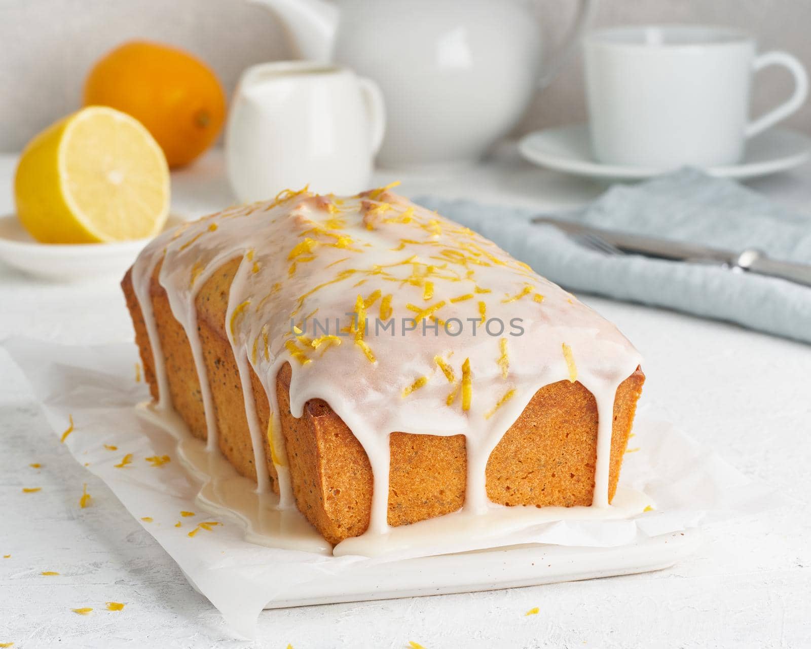 Lemon bread coated with sugar sweet. Cake with citrus, Whole loaf, side view, close up, vertical by NataBene