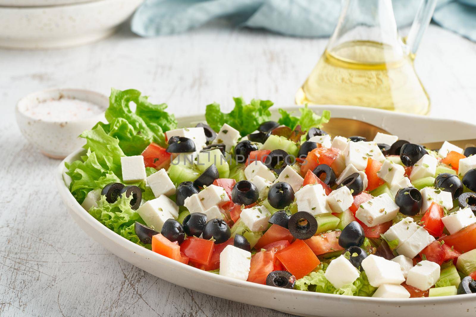 Greek salad Horiatiki with feta cheese, olives, tomato, cucumber, lettuce, vegeterian mediterranean food, low calories dieting meal