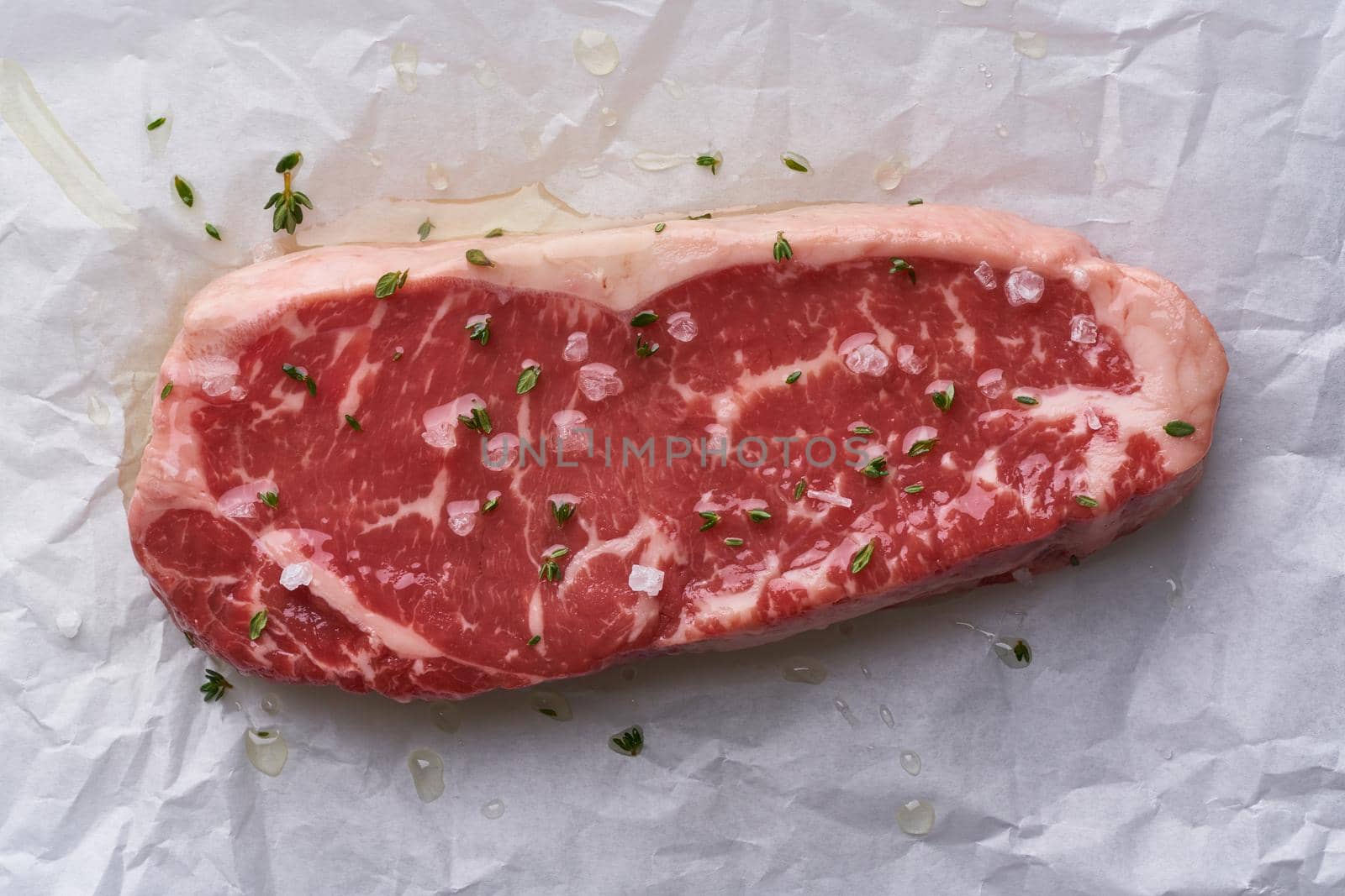 Raw Steak with seasoning and salt. Top view, close up by NataBene