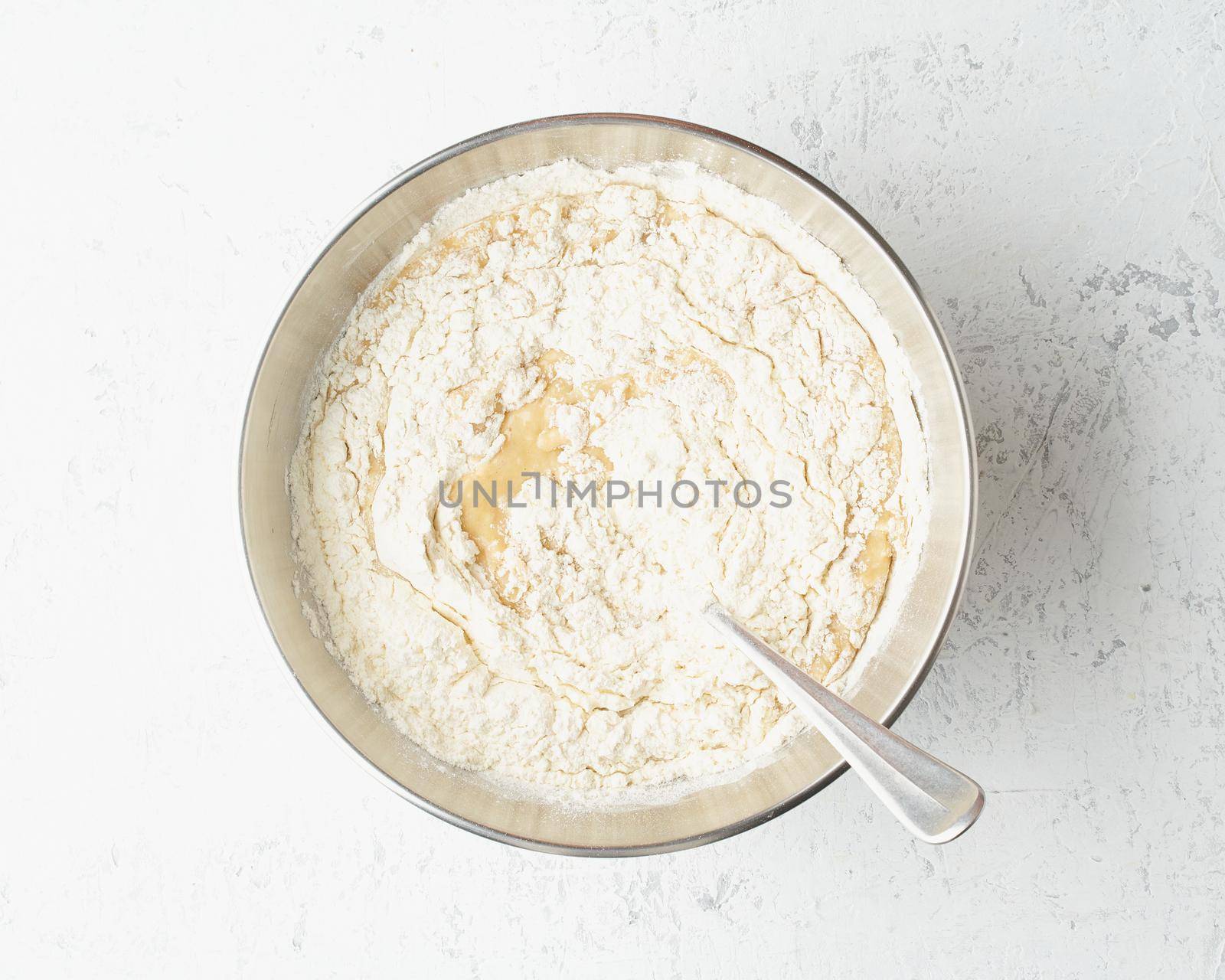 Homemade Banana bread. Dough for cake. Step by step recipe. Step 9. Mixed banana with sugar, eggs, yogurt and flour. Top view, white table.