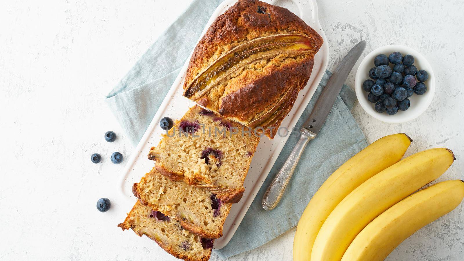 Homemade Banana bread. Baked cake. Top view, white table. by NataBene