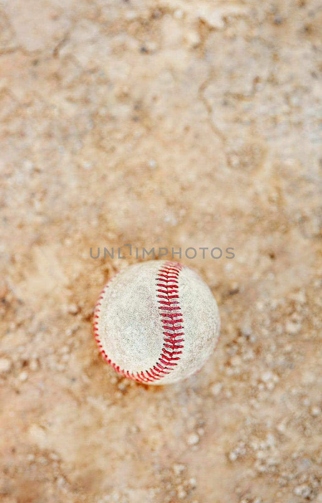 Still life shot of a baseball ball on the pitch outdoors during the day