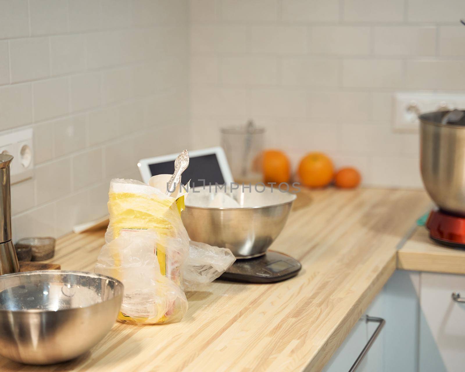 Cooking and baking food kitchen background at home, apartment, flour, scales, bowls, digital tablet with recipes on table