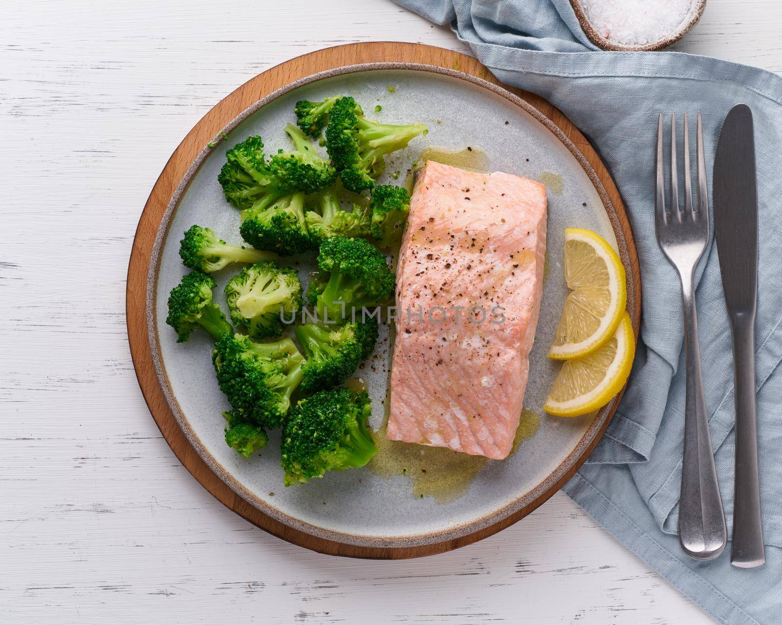 Steam salmon, broccoli, paleo, keto, lshf or dash diet. Mediterranean, Clean eating, balanced food. Gray ceramic plate on white table, top view
