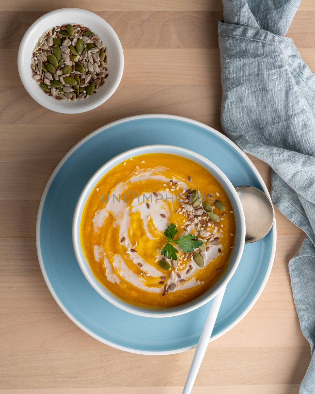 Pumpkin soup with coconut milk, vegetarian dish, healthy diet food, top view, vertical by NataBene