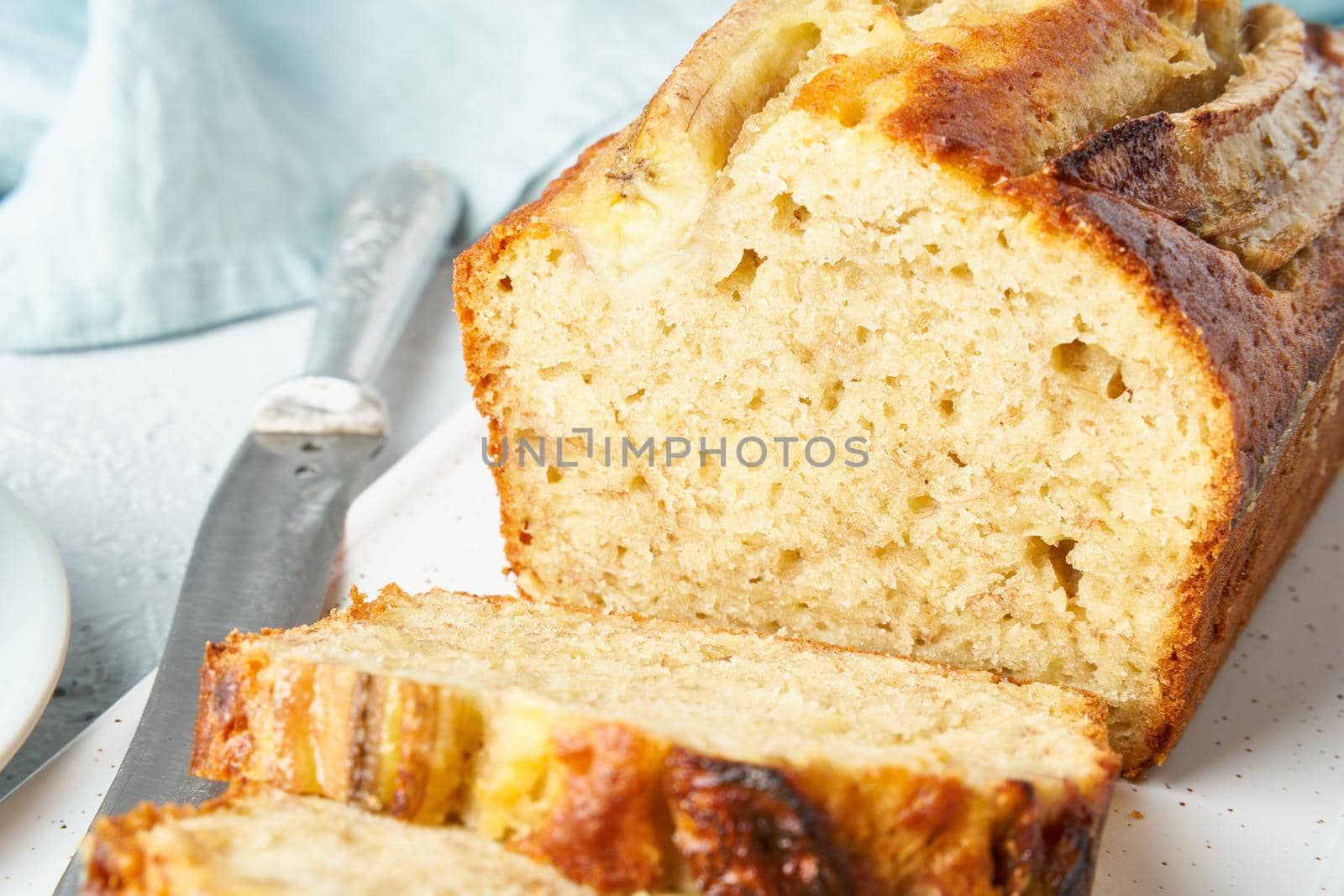 Banana bread. Cake with banana, traditional american cuisine. Slice of loaf. Gray background. Side view, close up