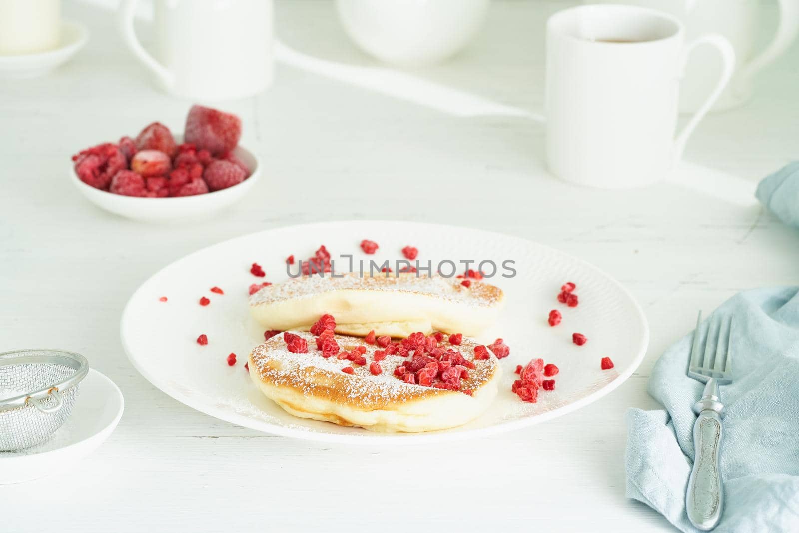 Fluffy japanese pancake, thick souffle. Trendy food. Delicious Breakfast on a white background. Side view