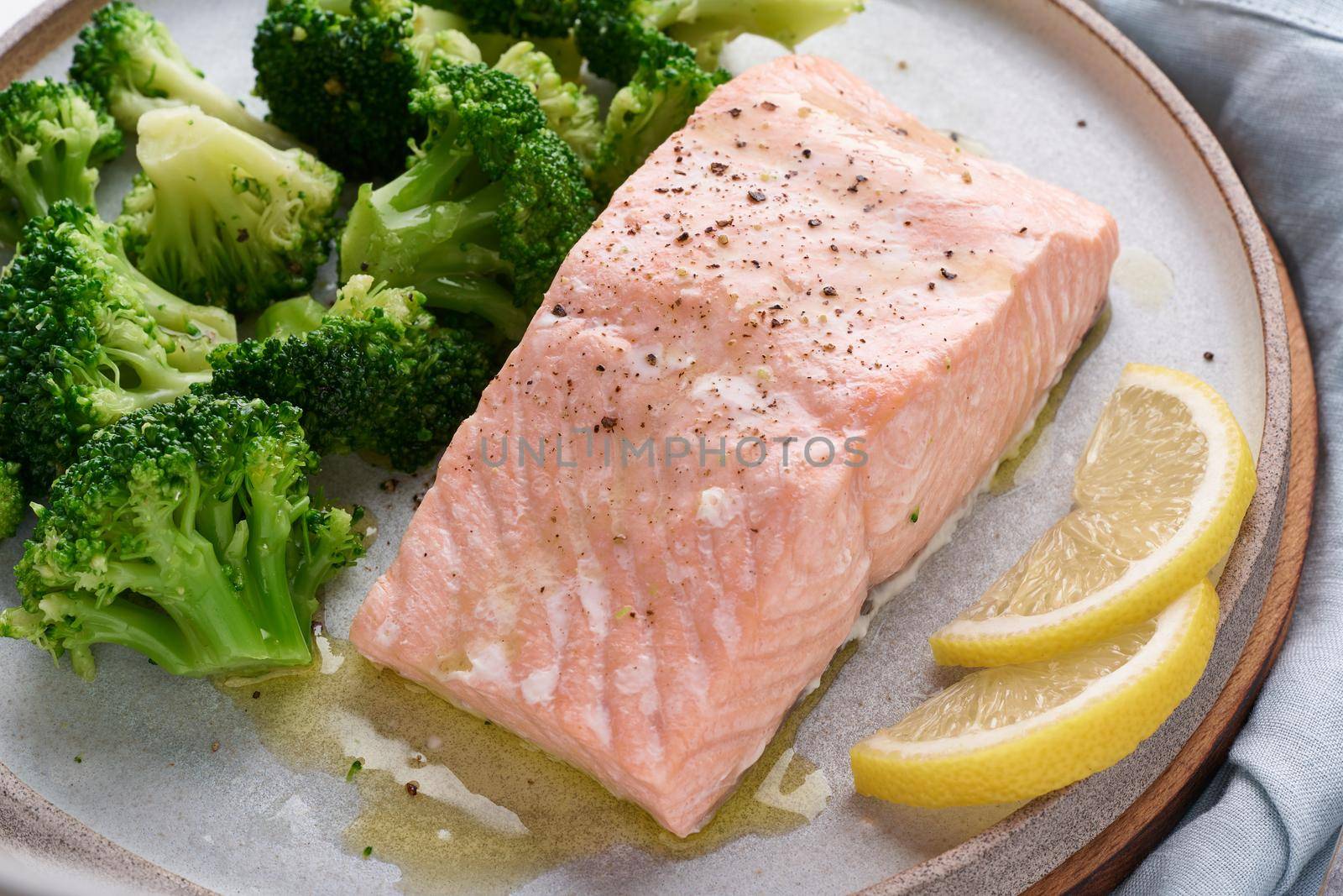 Steam salmon, broccoli, paleo, keto, lshf or dash diet. Mediterranean, Clean eating, balanced food. Gray ceramic plate on white table, macro