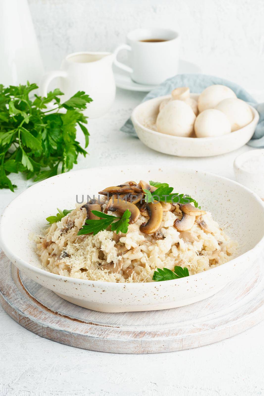 Risotto with mushrooms in plate. Rice porridge with mushrooms and parsley by NataBene