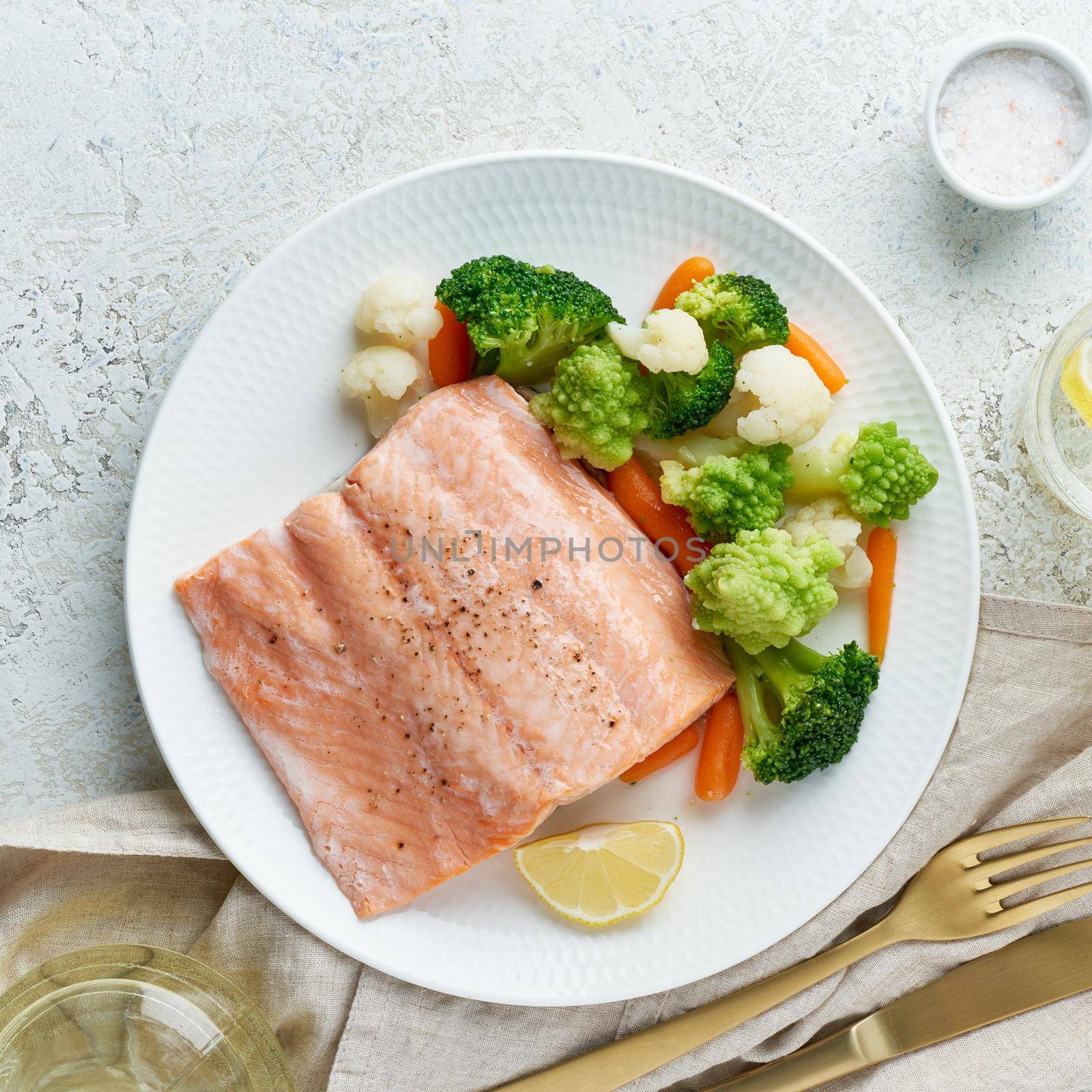 Steam salmon and vegetables, Paleo, keto, fodmap, dash diet. Mediterranean diet with steamed fish. Healthy concept, white plate on gray table, gluten free, lectine free, top view