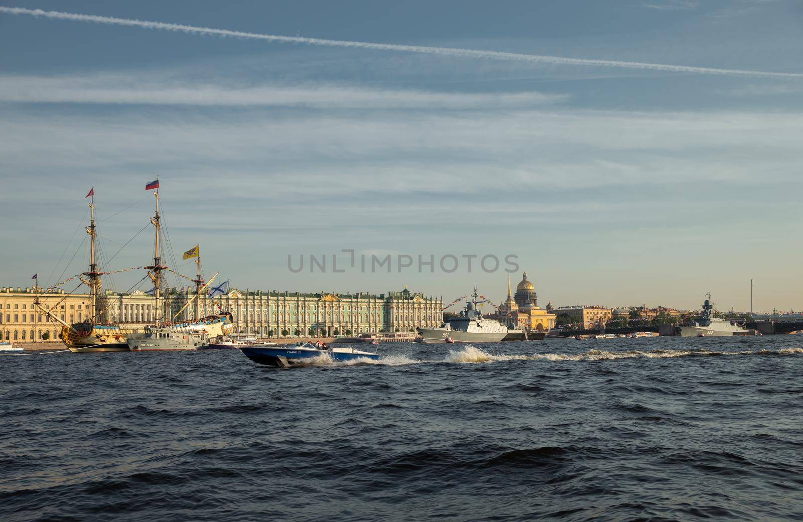 The landscape with warships in the Neva River before the holiday of the Russian Navy at sunny day, the latest cruisers among landmarks, Palace bridge. High quality photo