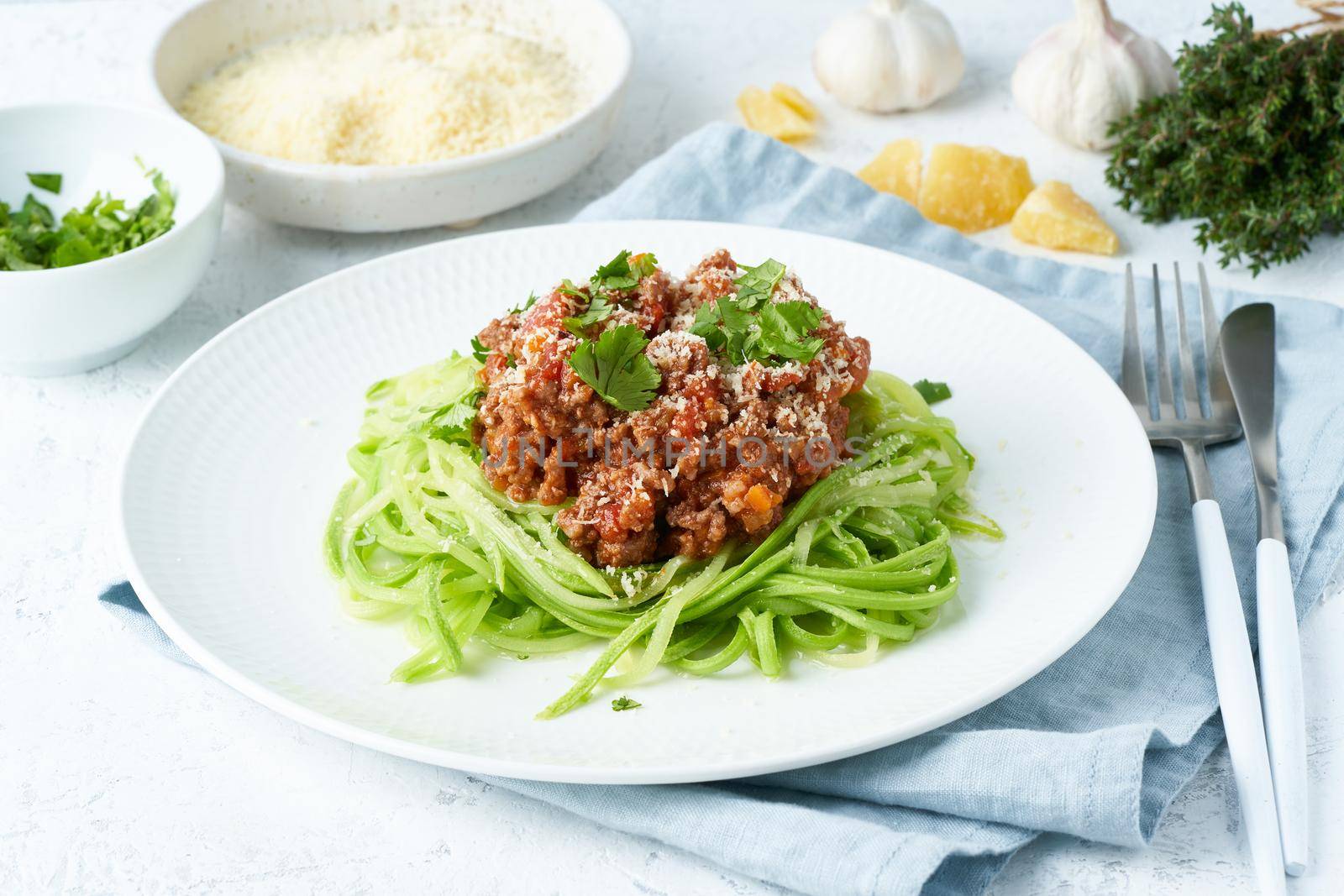 Keto pasta Bolognese with mincemeat and zucchini noodles, fodmap, lchf, low carb, ketogenic diet. Side view, close up. Clean eating, balanced food.