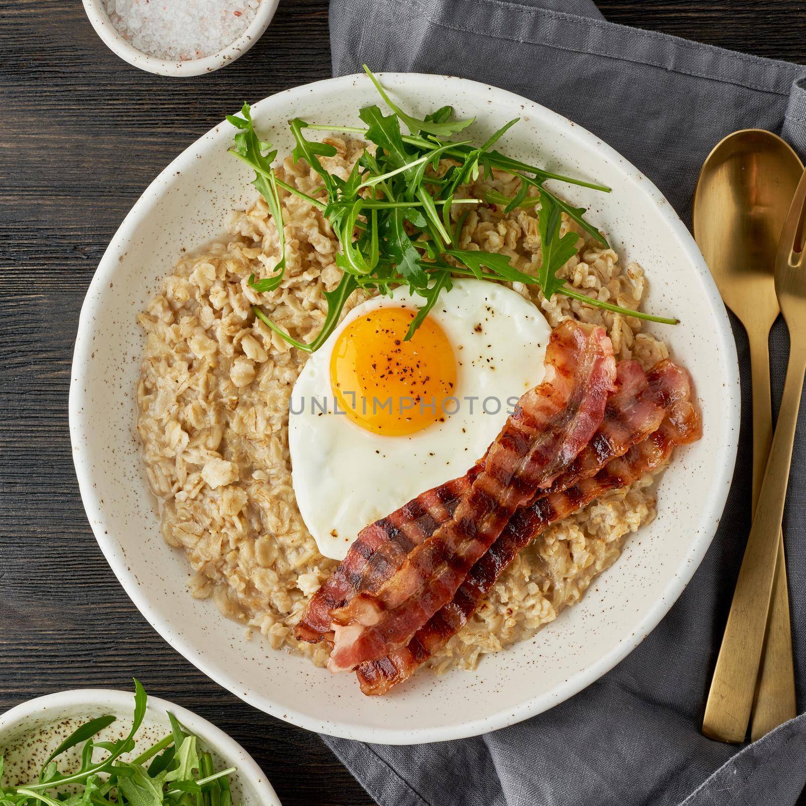 Oatmeal, fried egg and fried bacon. Brutal man sport breakfast. Hearty fat breakfast. Macro by NataBene