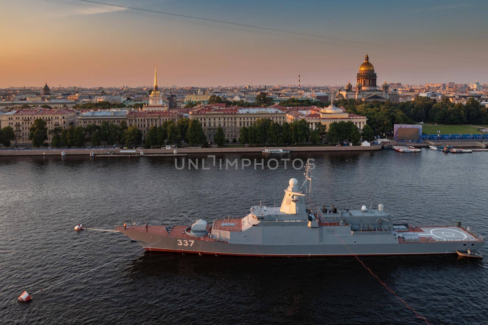 Aerial morning urban landscape with warships in the waters of the Neva River before the holiday of the Russian Navy, sea power, the latest cruisers among the sights, Isaac cathedral on a background. High quality photo