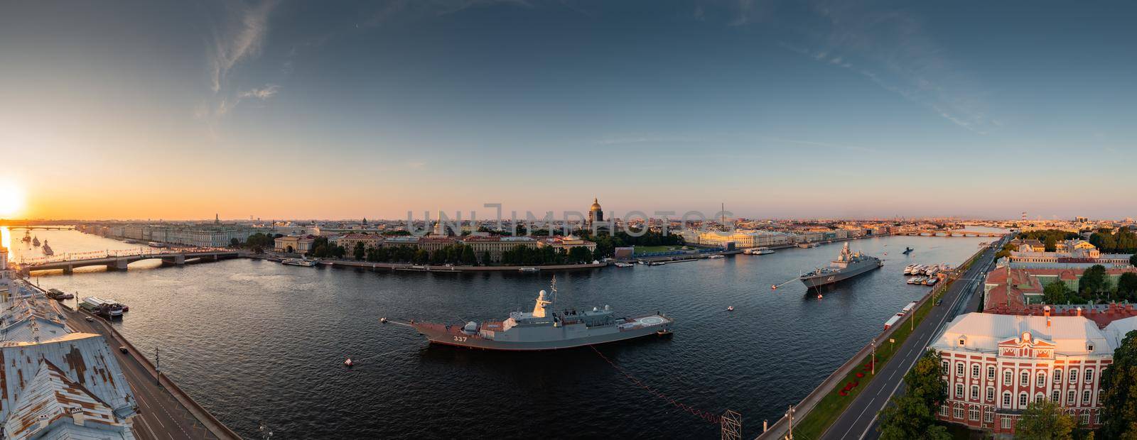 Aerial panoramic landscape of warships in the waters of the Neva River before the holiday of the Russian Navy, sea power, the latest cruisers among the sights, Isaac cathedral on a background. High quality photo