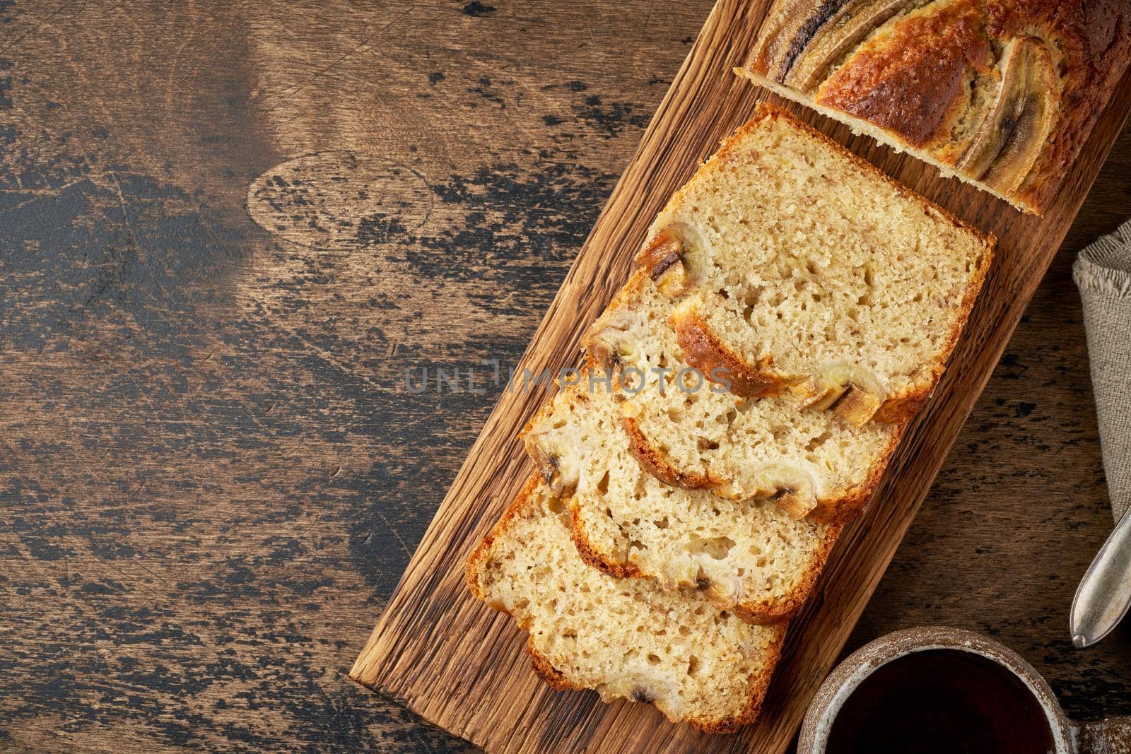 Banana bread. Cake with banana, traditional american cuisine. Slices of loaf. Dark background by NataBene