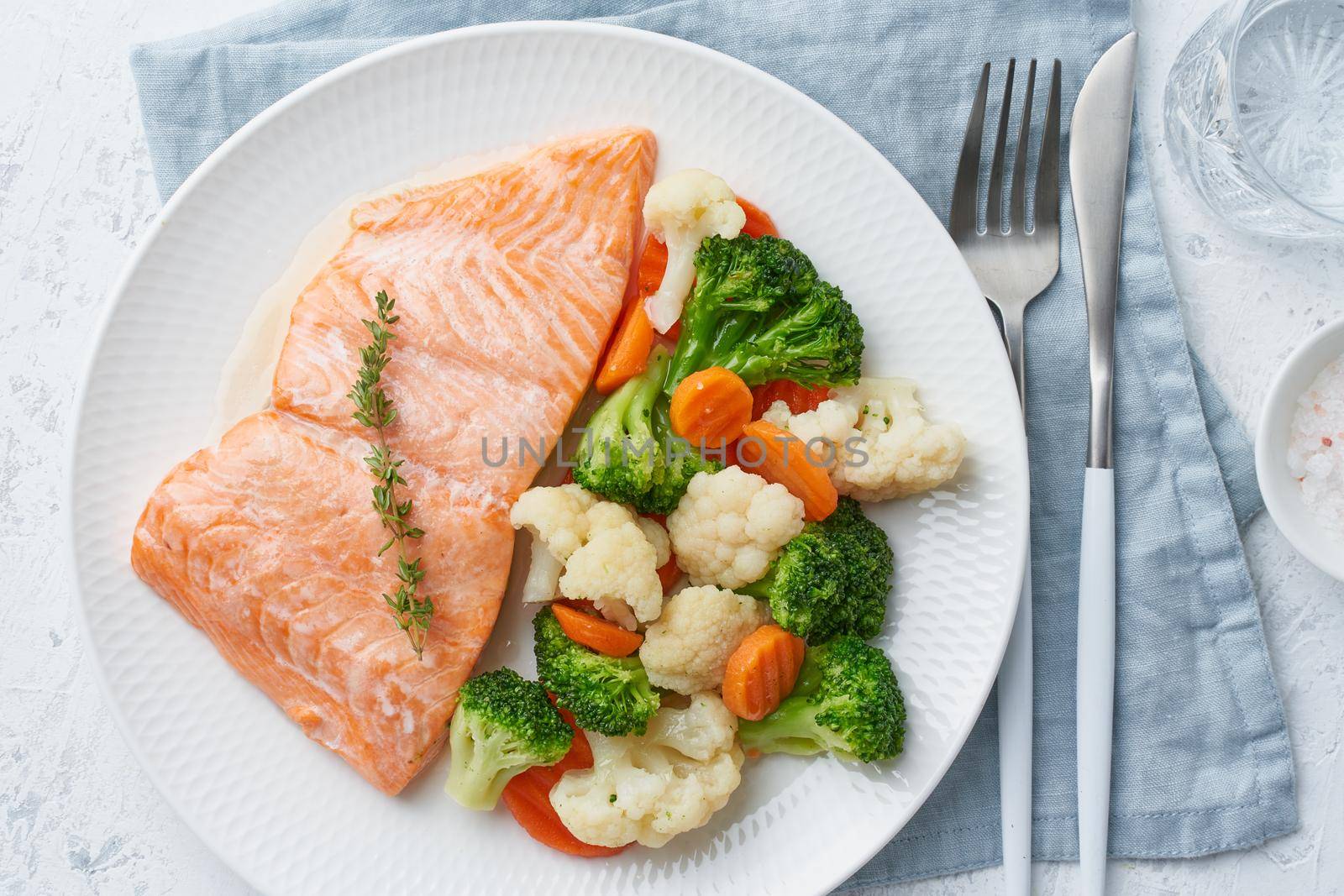 Steam salmon and vegetables, Paleo, keto, fodmap, dash diet. Mediterranean diet with steamed fish. Healthy concept, white plate on gray table, gluten free, lectine free, top view