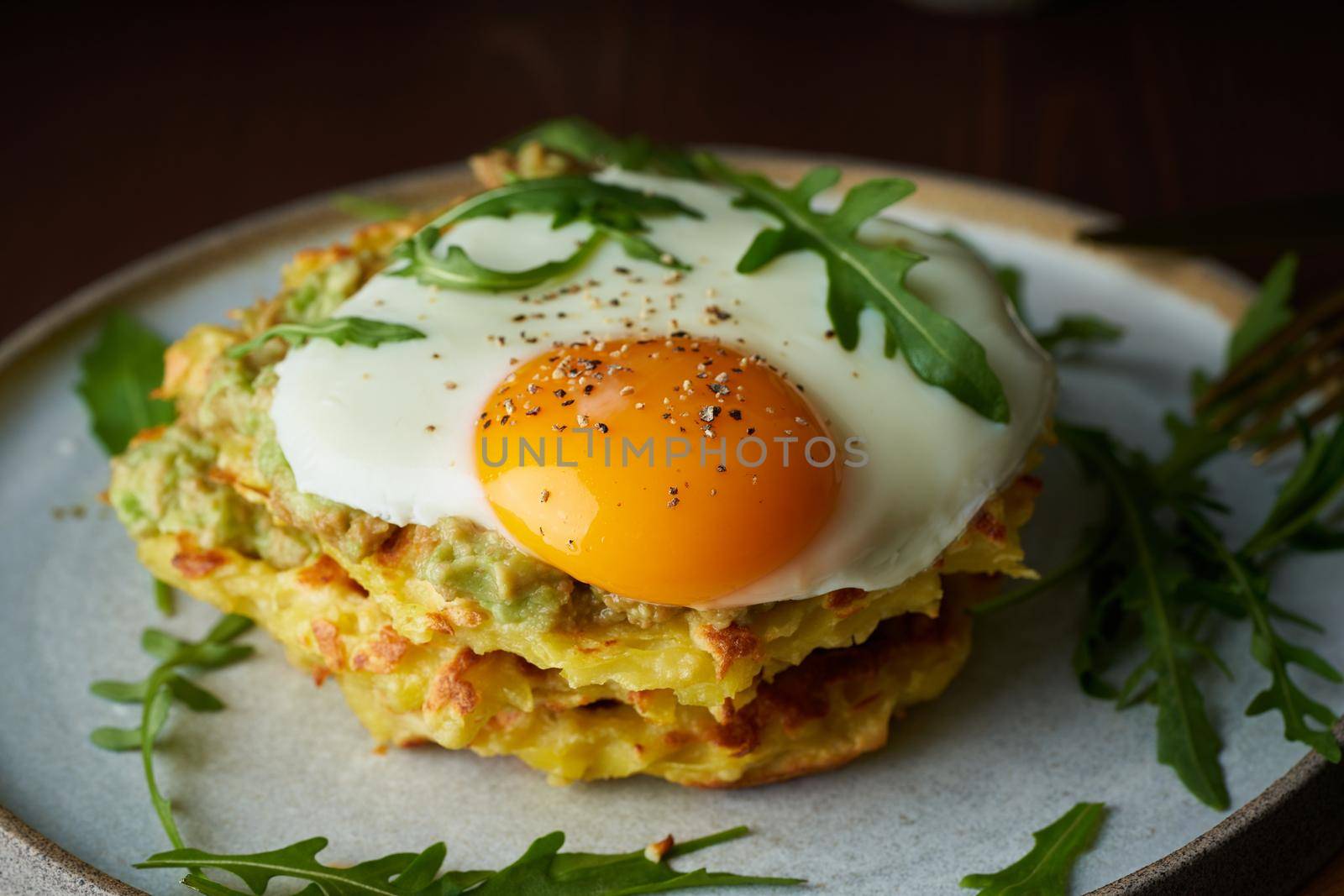 Chaffles, ketogenic diet health food. Homemade keto waffles with fried egg, mozzarella cheese. Gluten free and carb free. Dark background, close up