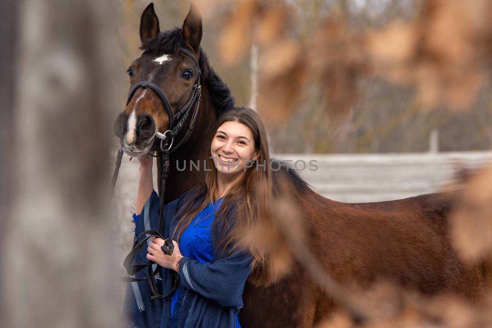 Portrait of a happy beautiful girl of Slavic appearance and a horse a