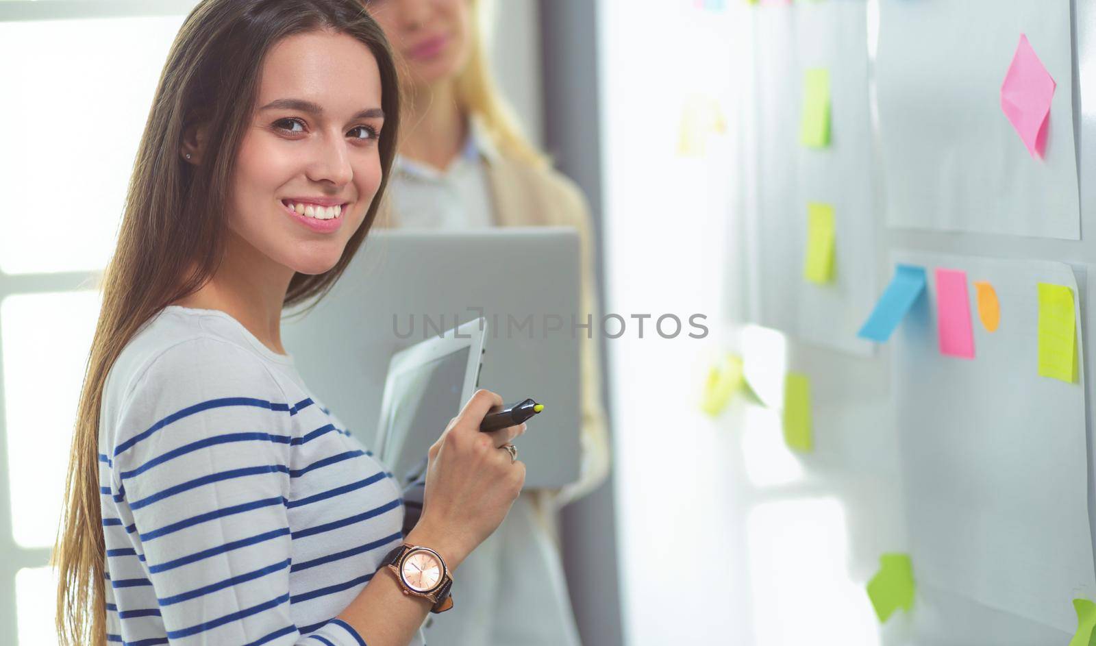 Beautiful smiling pregnant woman with the doctor at hospital.