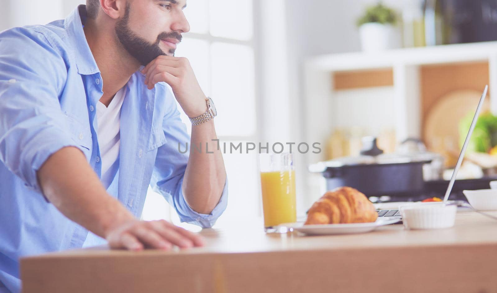 Man preparing delicious and healthy food in the home kitchen.