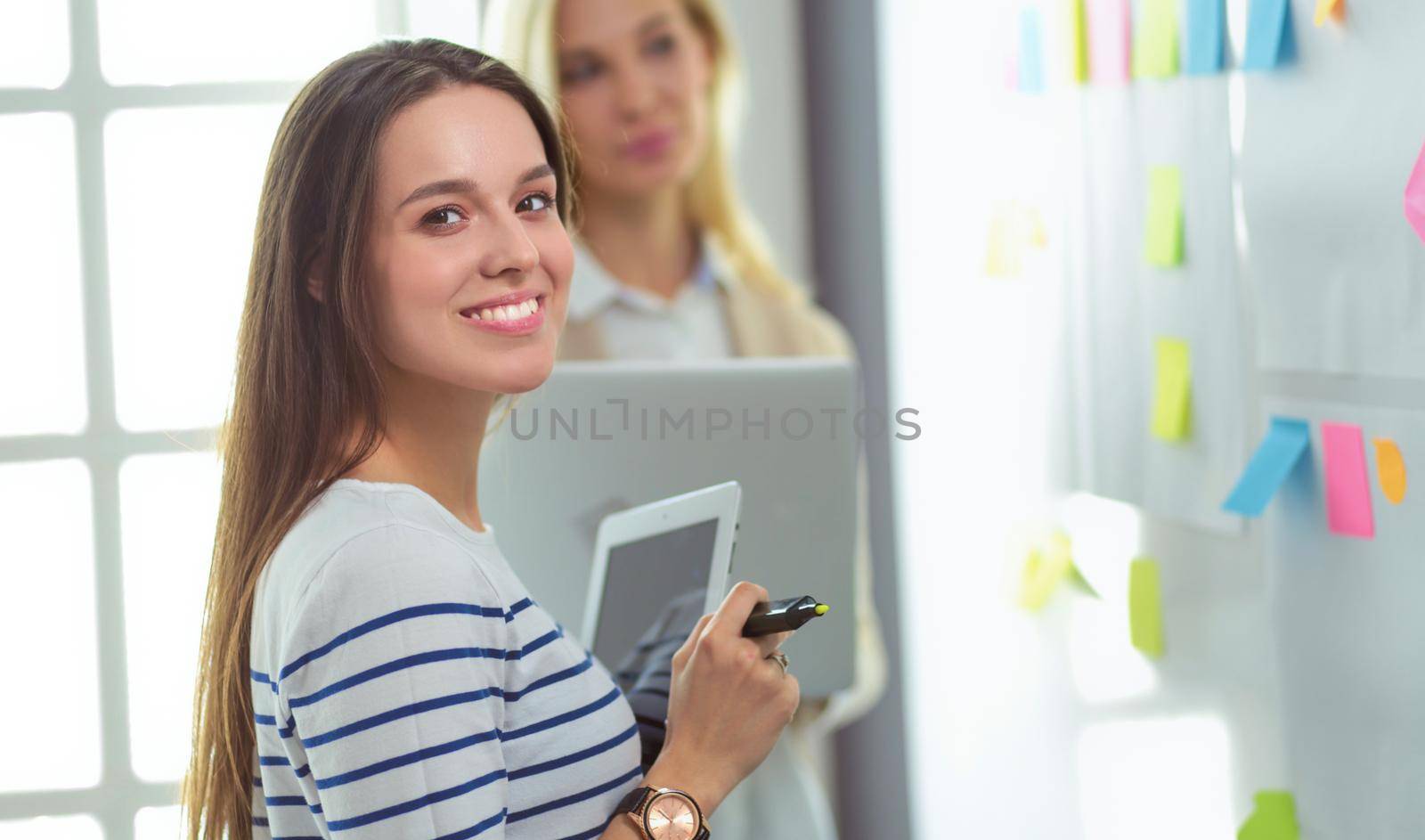 Beautiful smiling pregnant woman with the doctor at hospital.