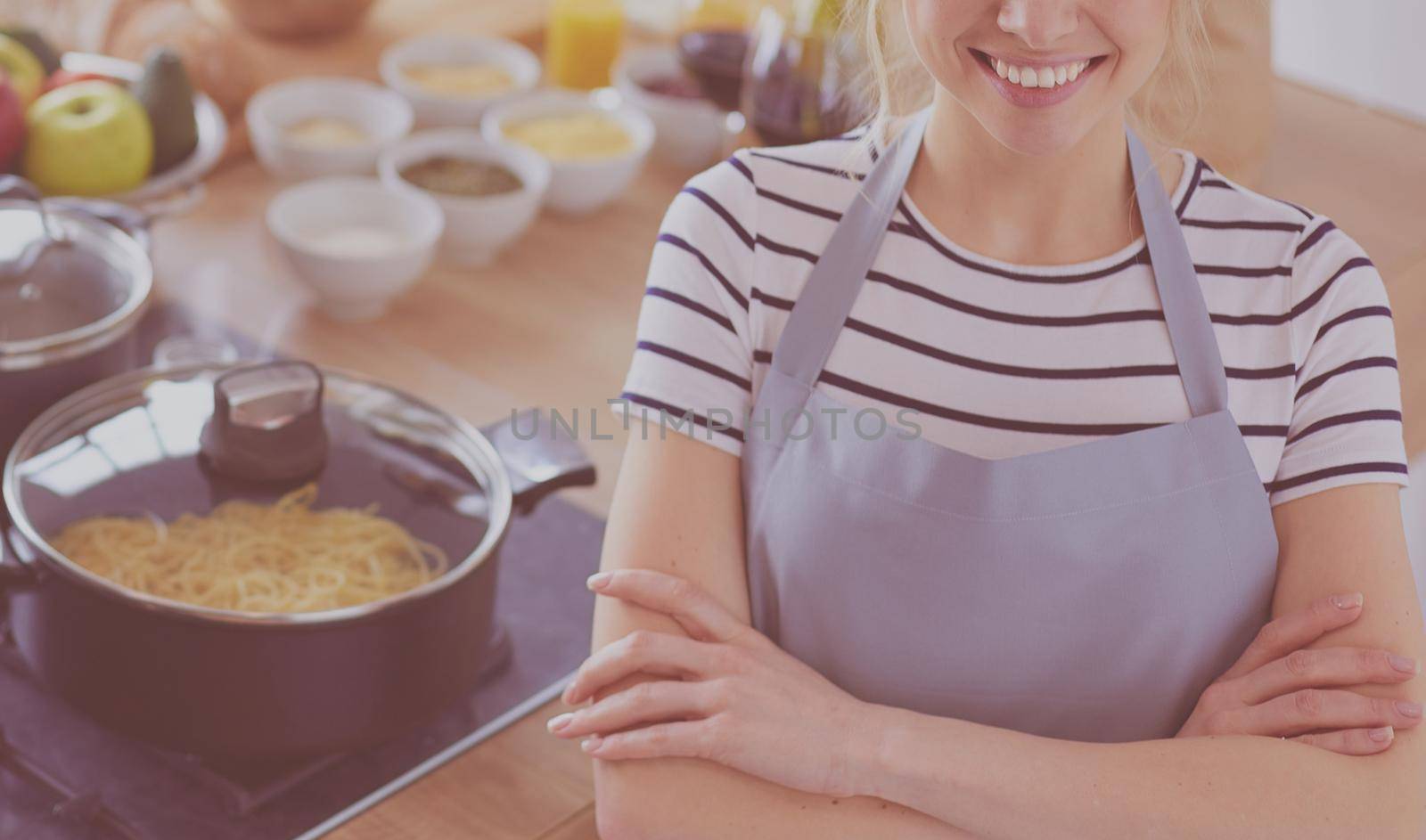 Young woman standing near desk in the kitchen .