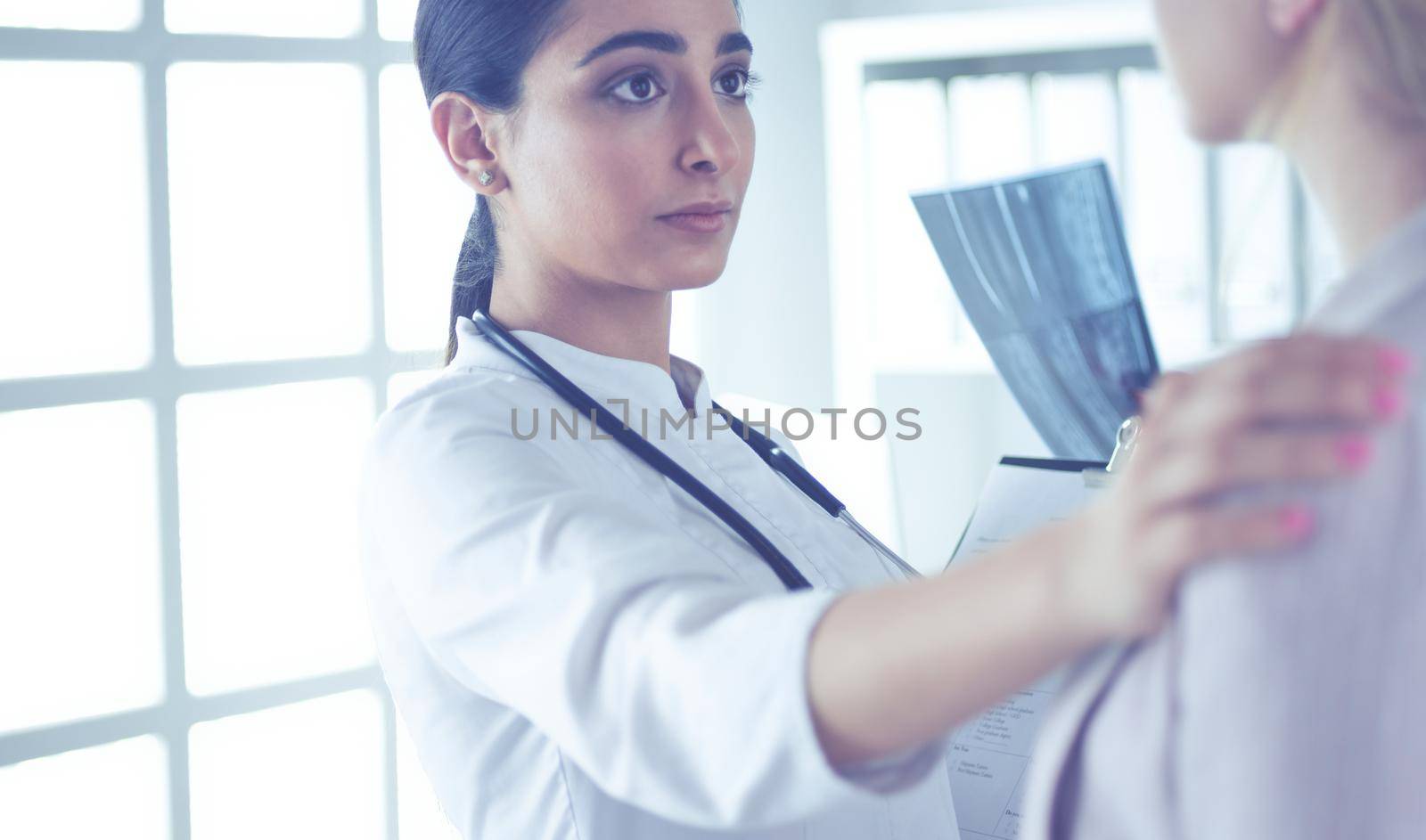 Healthcare and medical concept - doctor with patient in hospital.