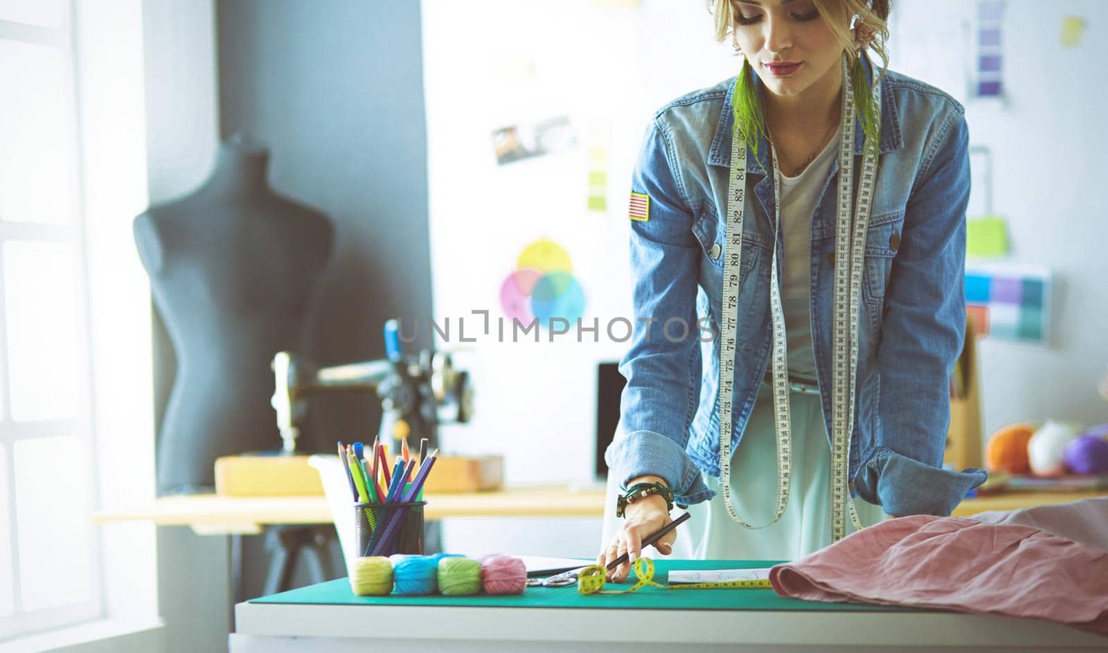 Fashion designer woman working on her designs in the studio.