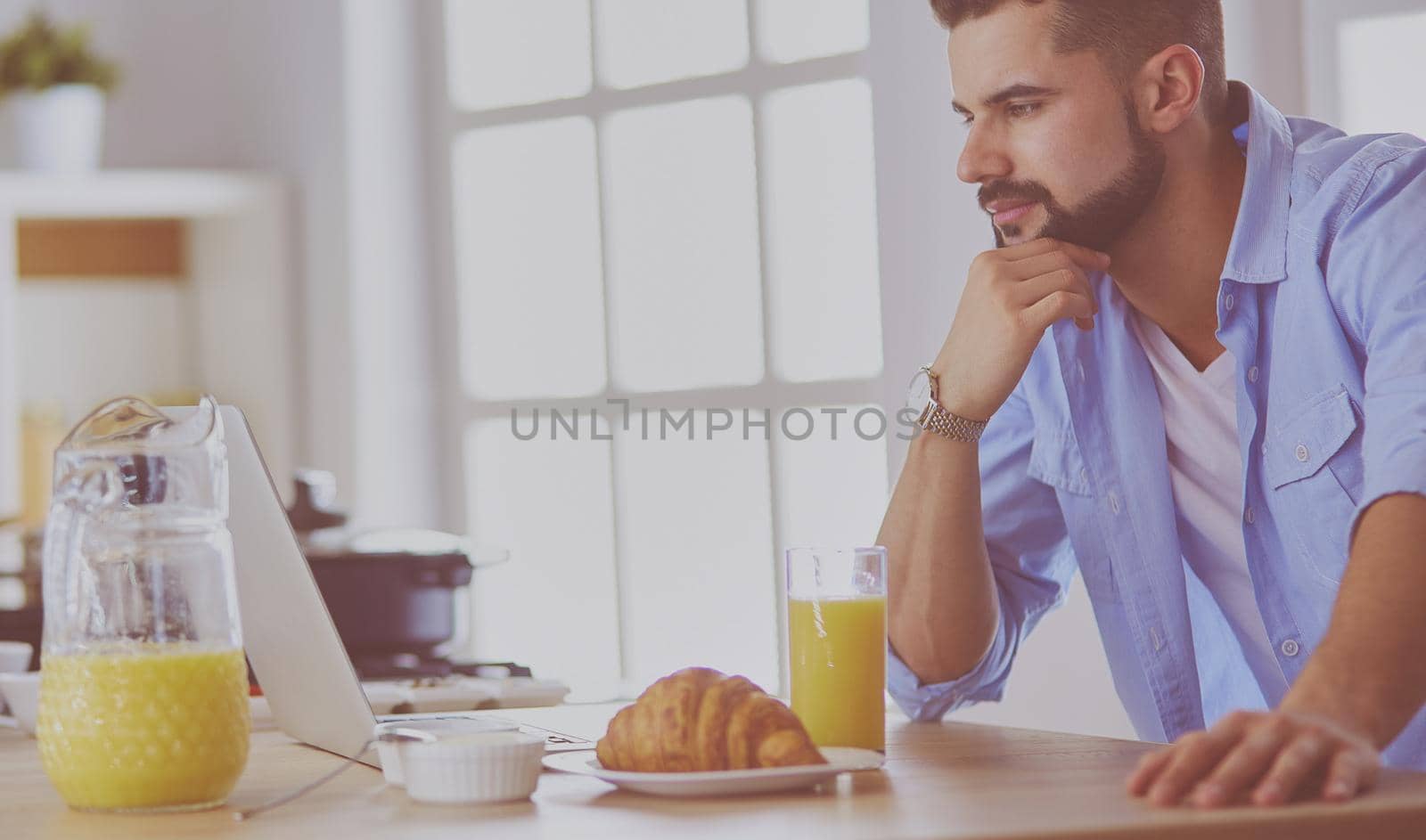 Man preparing delicious and healthy food in the home kitchen.