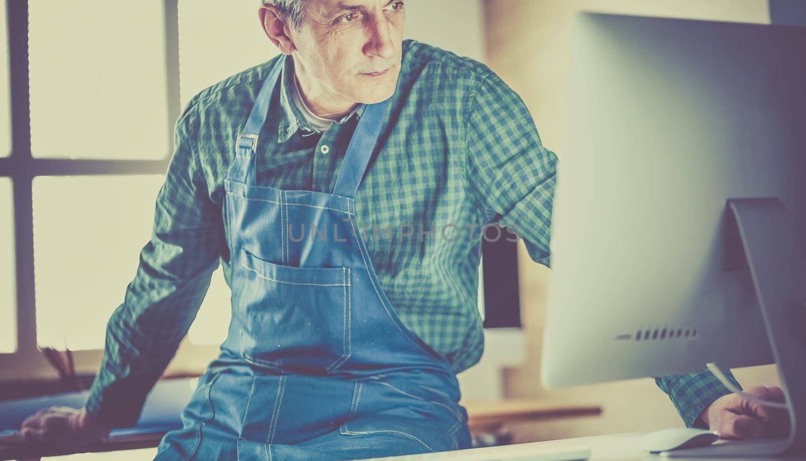 Architect working on drawing table in office.
