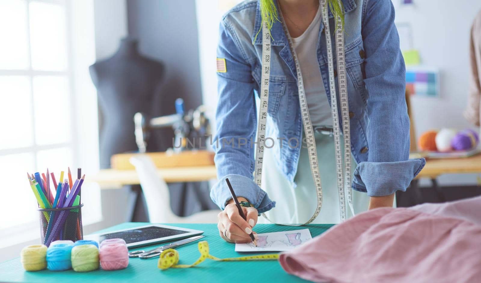 Fashion designer woman working on her designs in the studio.