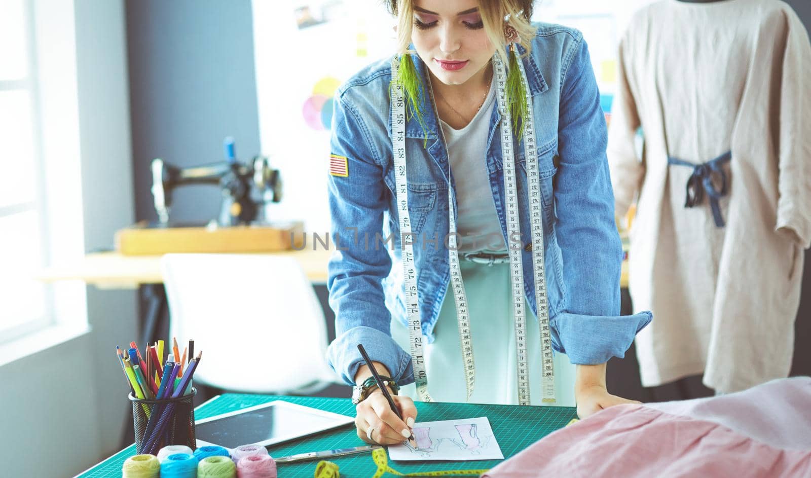Fashion designer woman working on her designs in the studio.