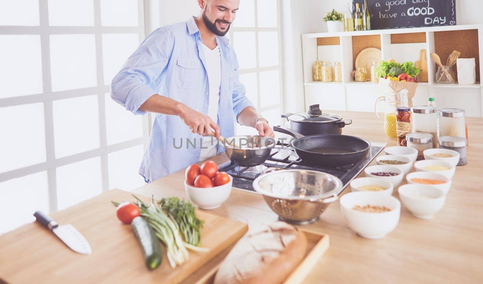 Man preparing delicious and healthy food in the home kitchen.