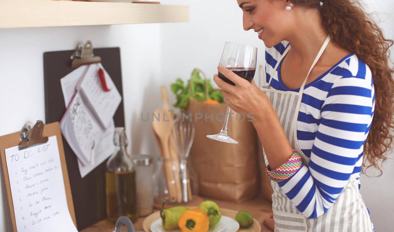 Attractive woman preparing food in the kitchen, standing