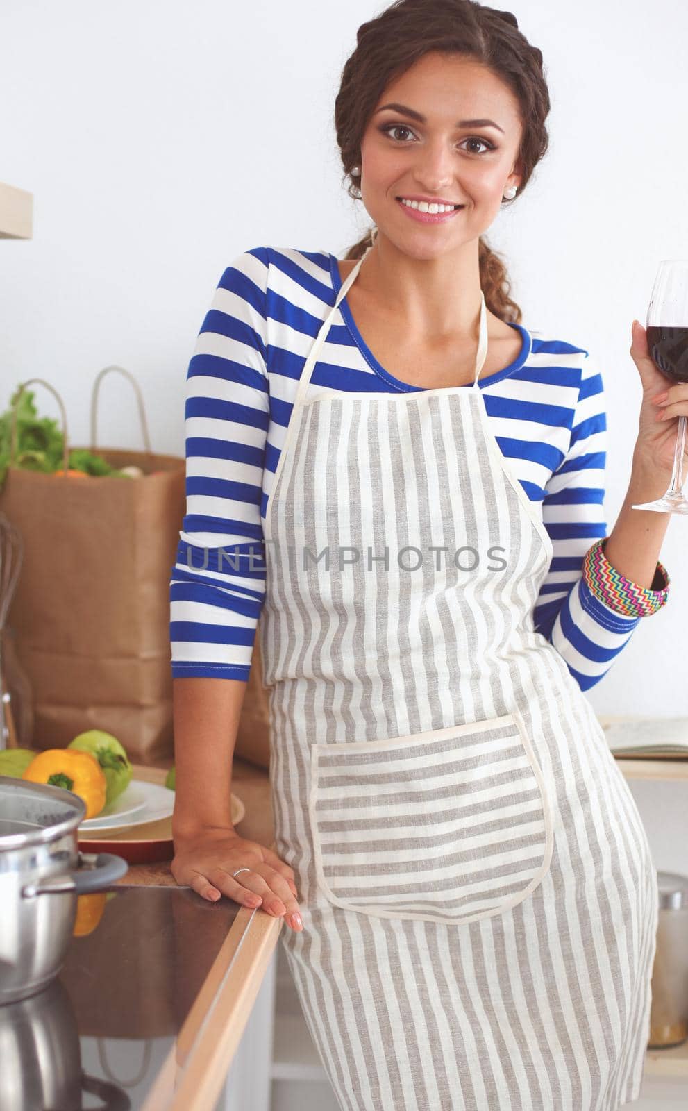 Attractive woman preparing food in the kitchen, isolated