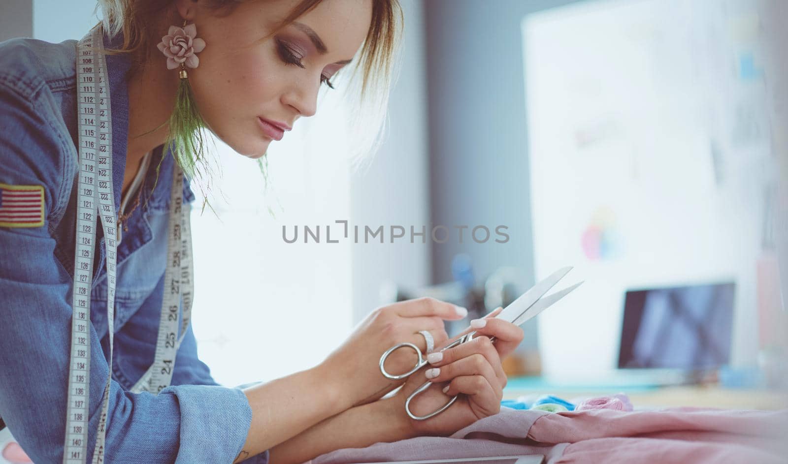 Fashion designer woman working on her designs in the studio.