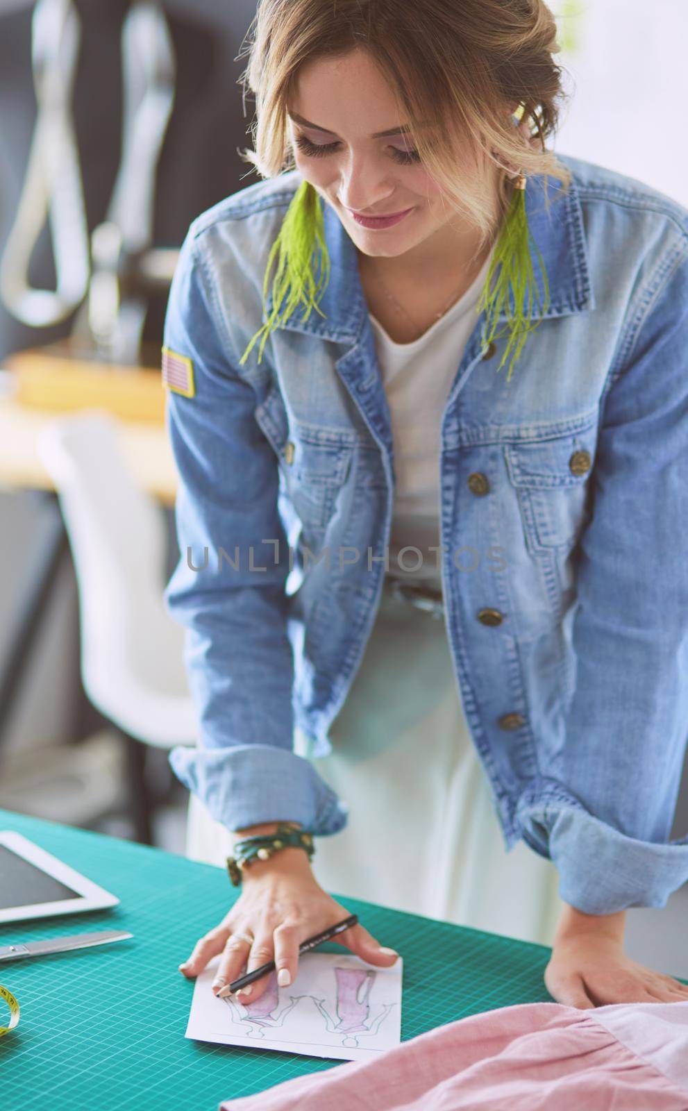Fashion designer woman working on her designs in the studio.
