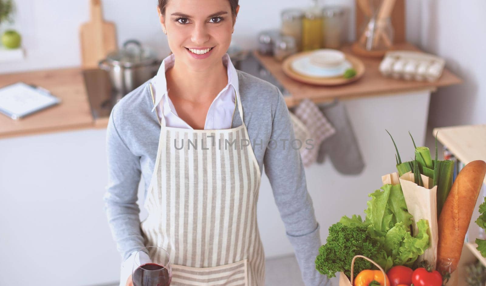Woman with shopping bags in the kitchen at home