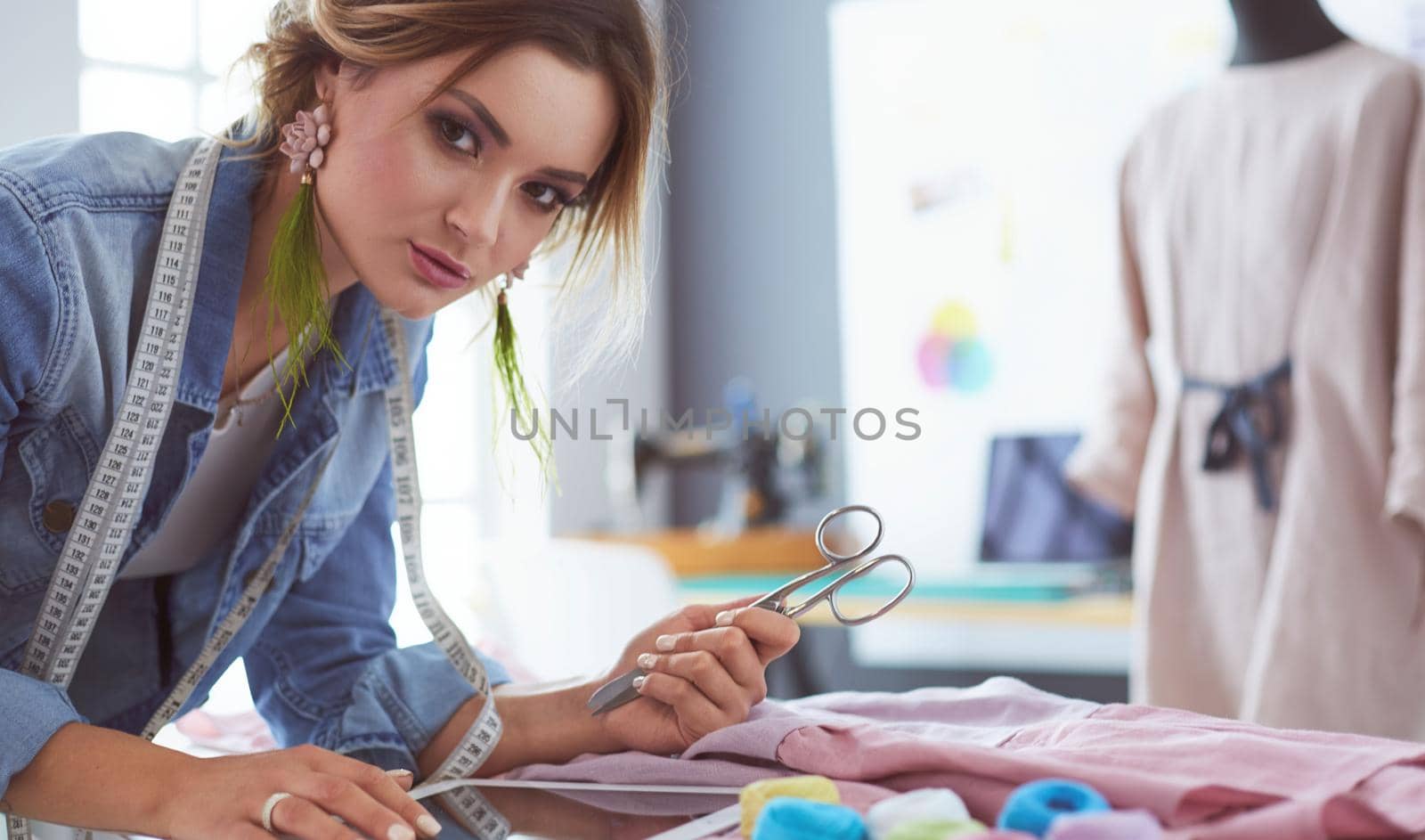 Fashion designer woman working on her designs in the studio.