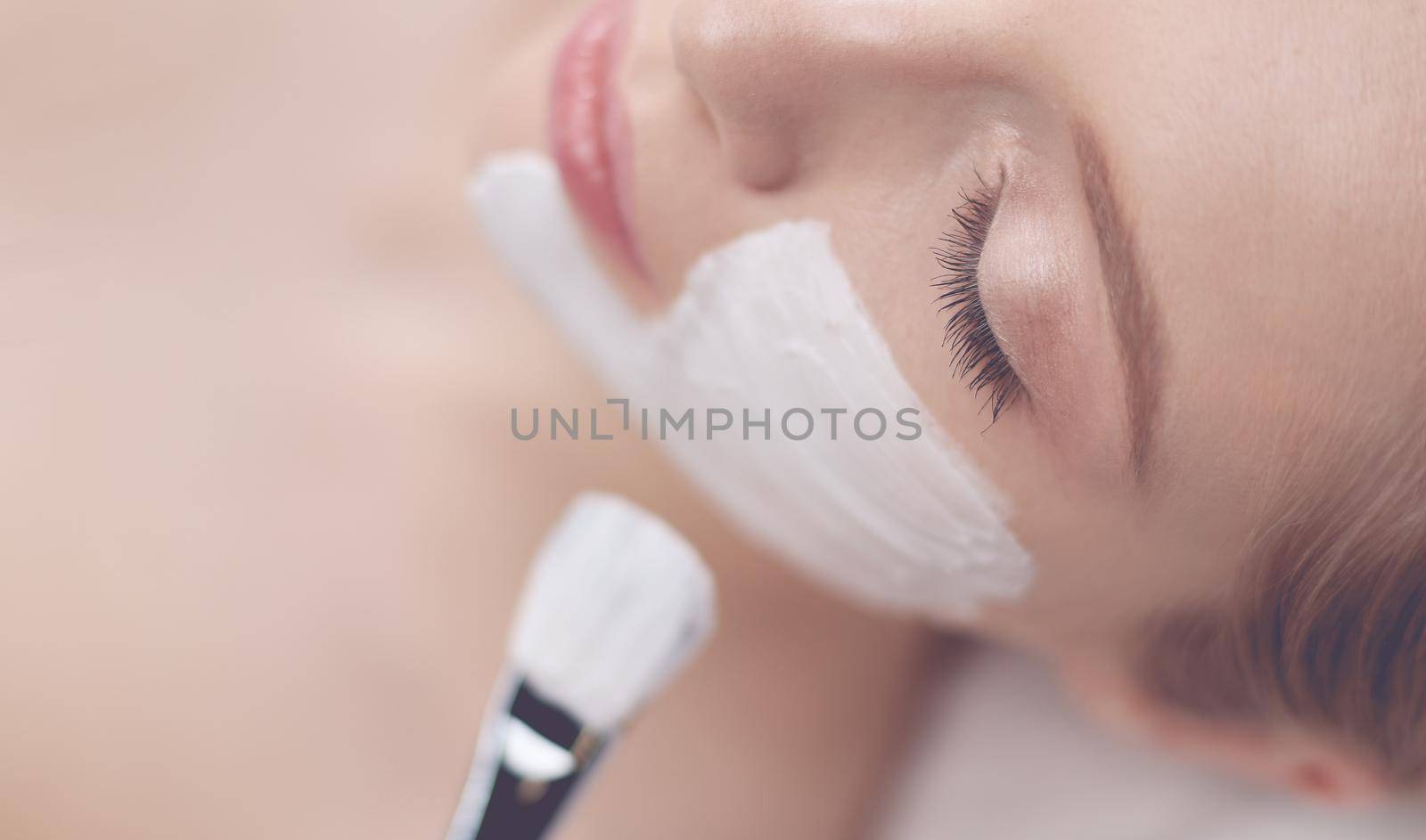 Spa facial mask application. Spa beauty organic facial mask application at day spa salon.