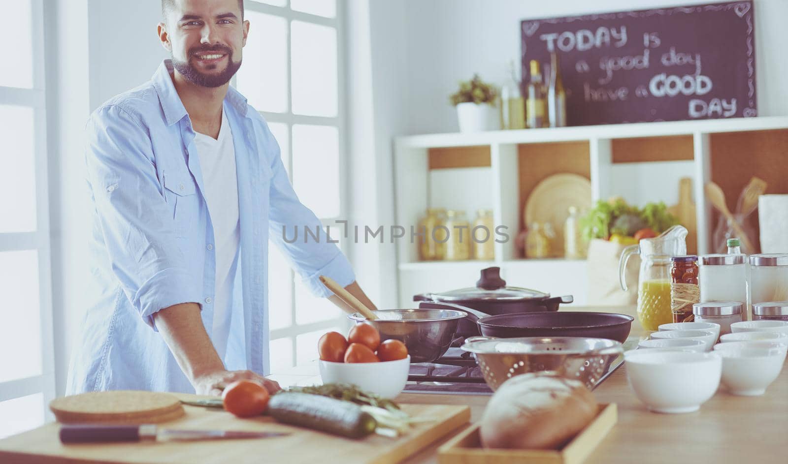 Man preparing delicious and healthy food in the home kitchen.