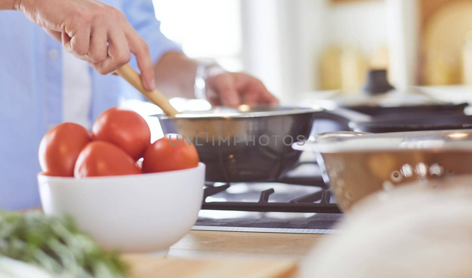 Man preparing delicious and healthy food in the home kitchen.