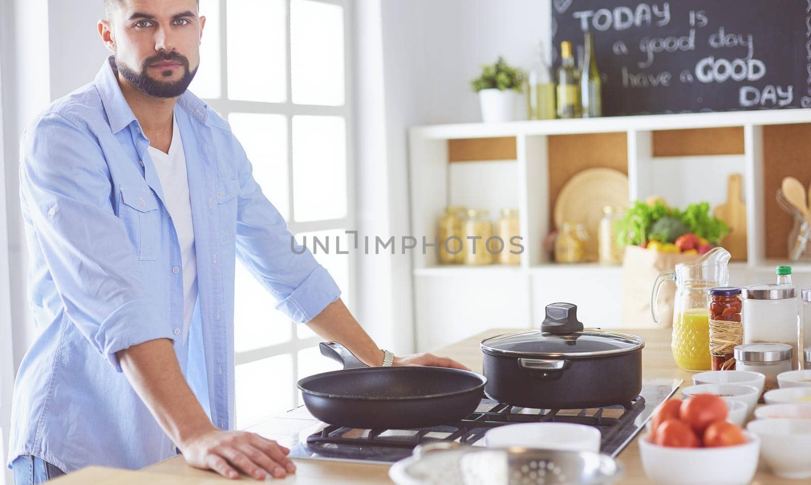 Man preparing delicious and healthy food in the home kitchen.