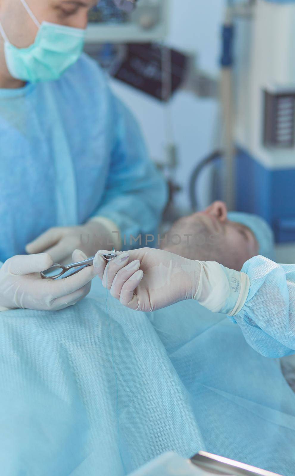 Man surgeon at work in operating room.