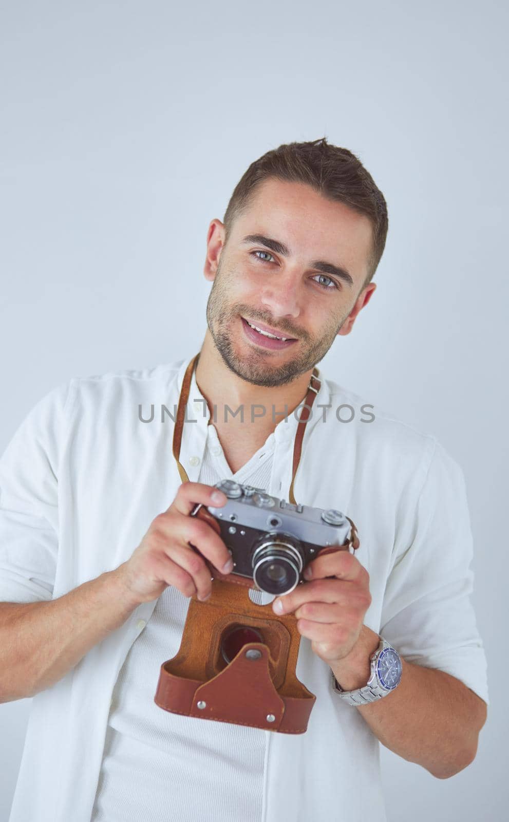 Young man with camera. Isolated over white background