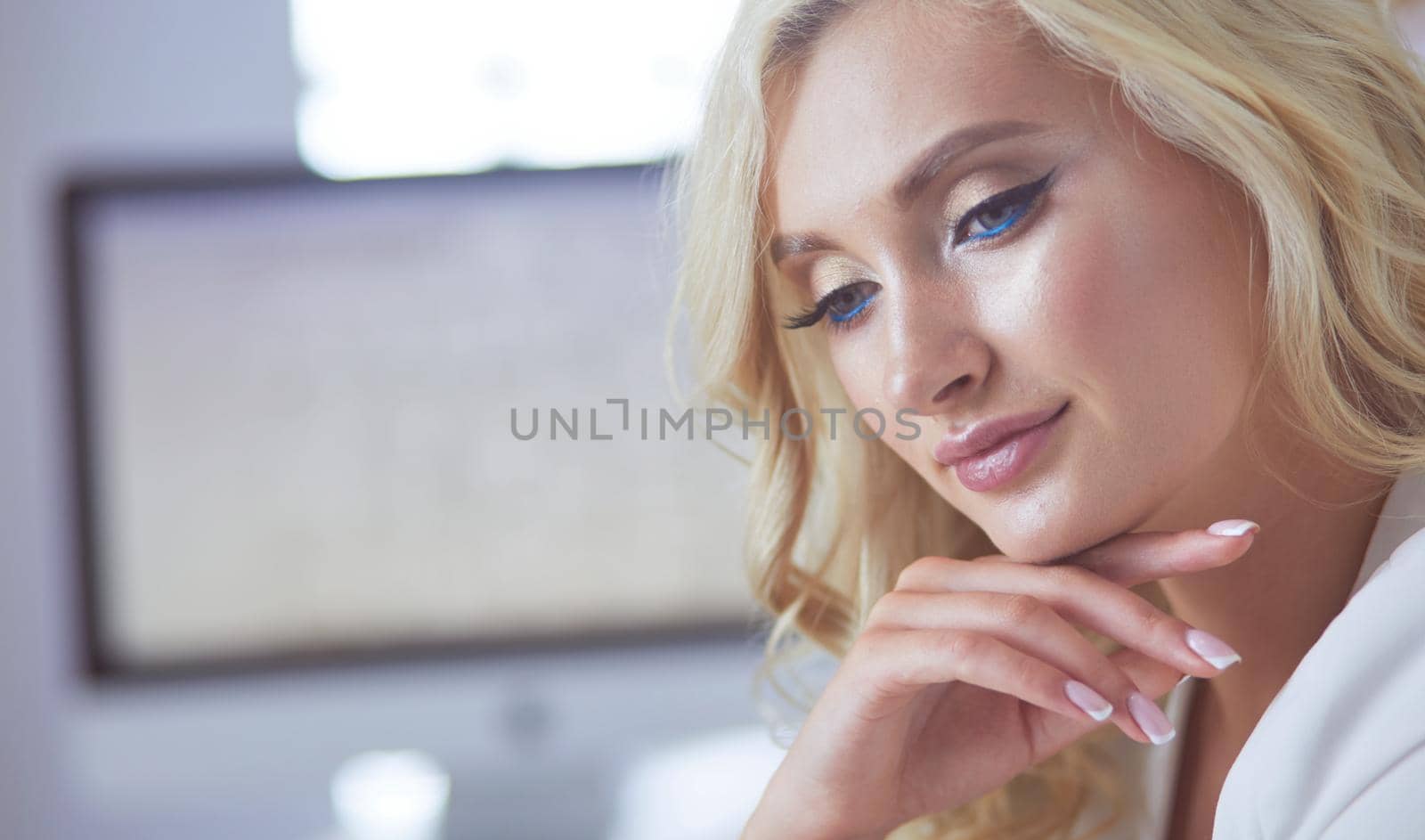 Beautiful young woman portrait , sitting in office